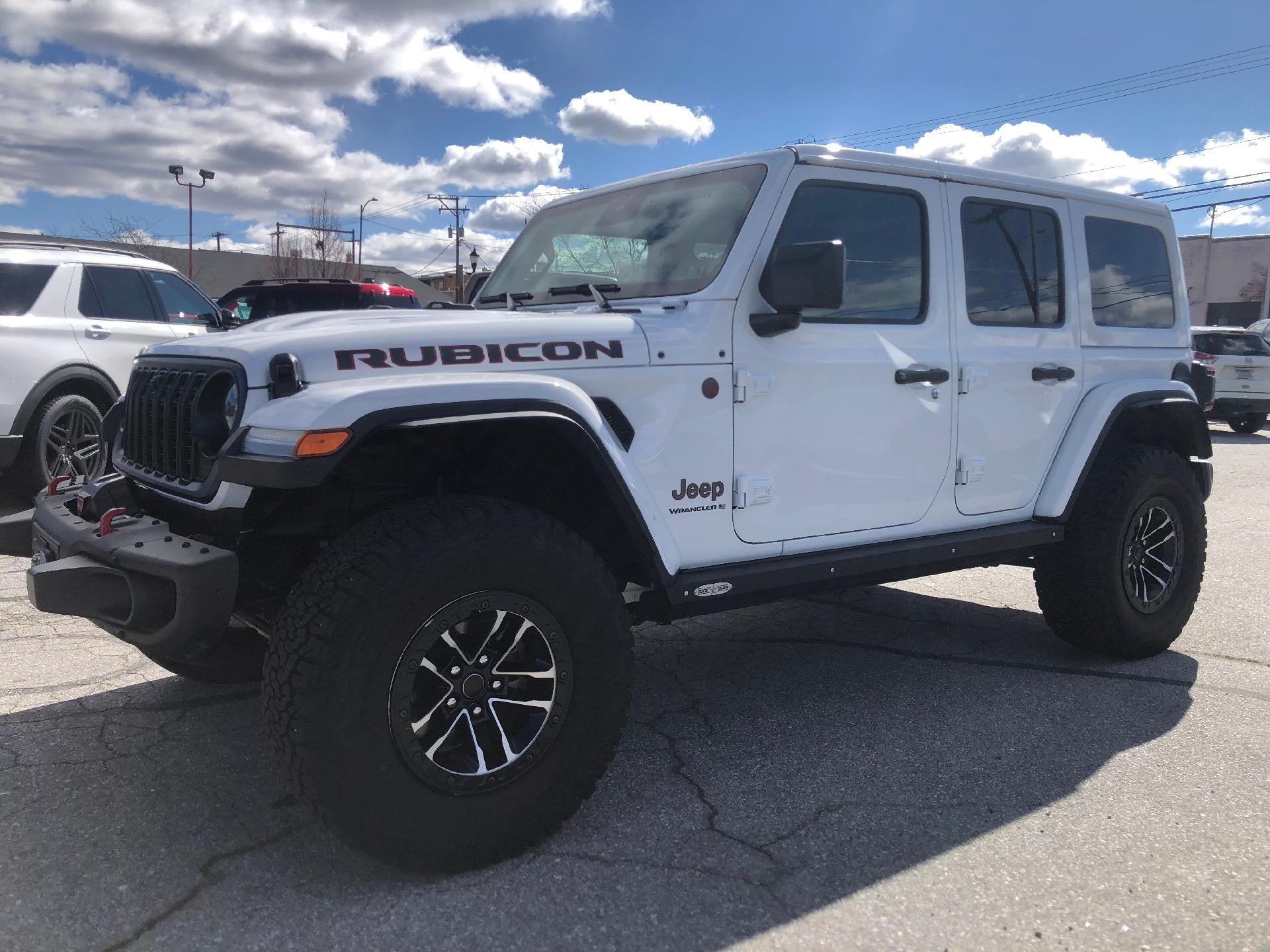 2024 Jeep Wrangler 4 door in Bright White Clearcoat — front three-quarter view