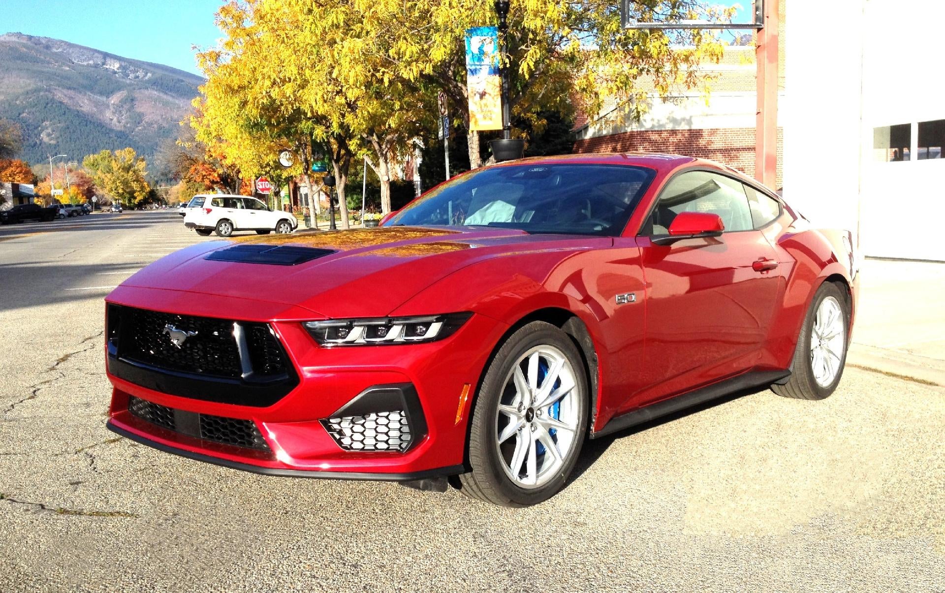 2024 Ford Mustang GT Fastback in Rapid Red Metallic Tinted Clearcoat — front three-quarter view