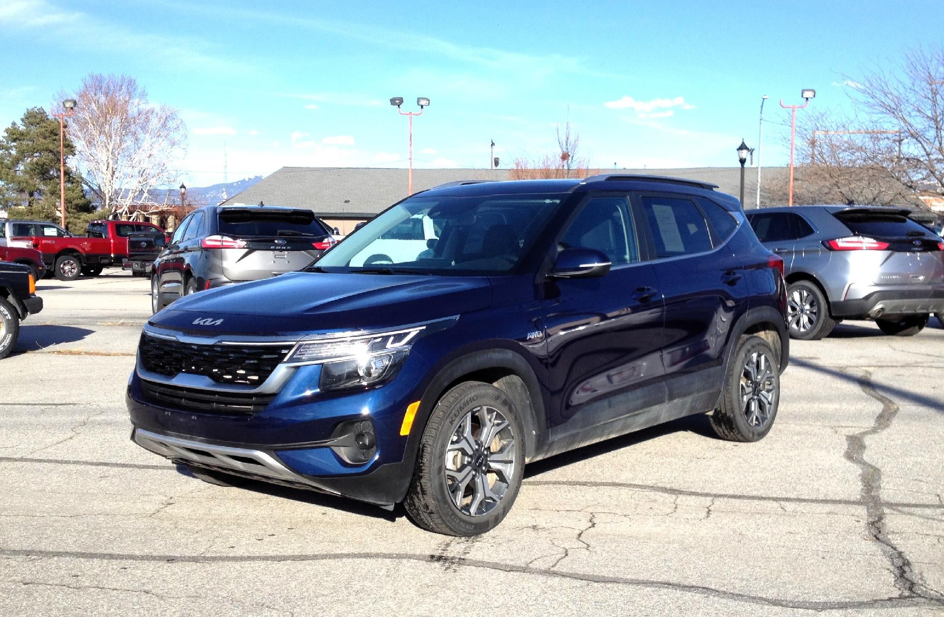 2023 Kia Seltos EX IVT AWD in Dark Ocean Blue — front three-quarter view
